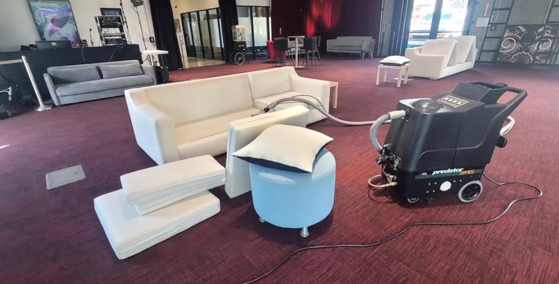 Event venue sofas being cleaned on red carpet